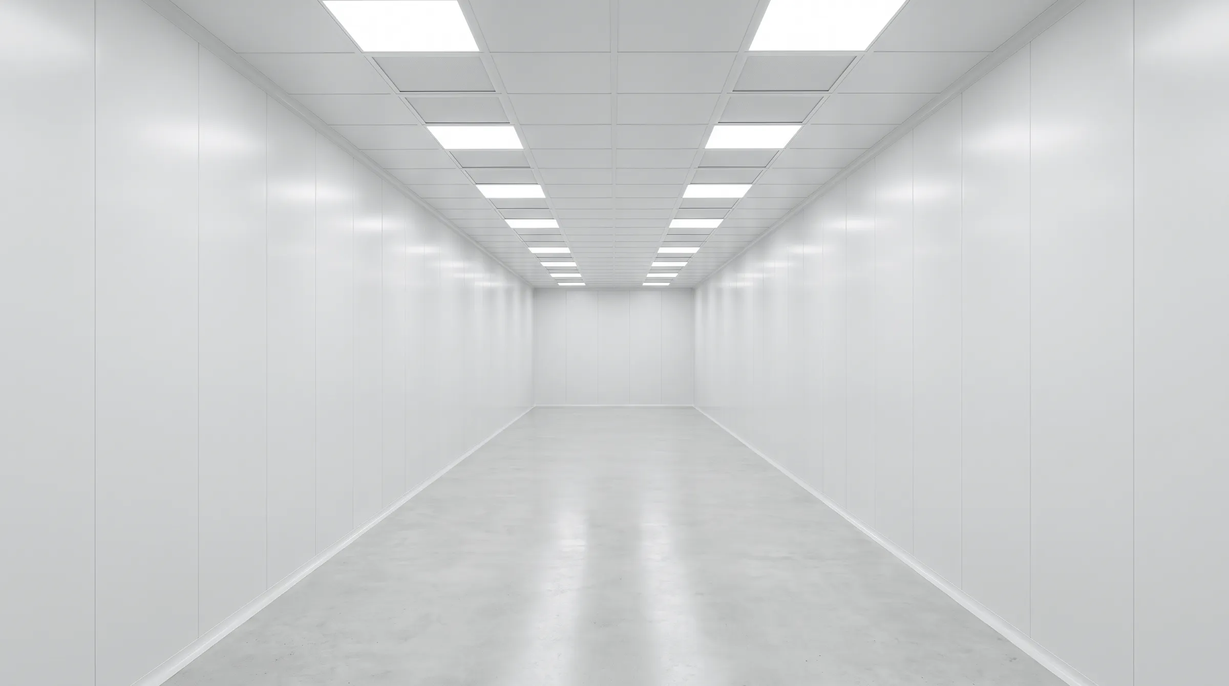 A symmetrical white clean-room corridor under a grid of ceiling lights
